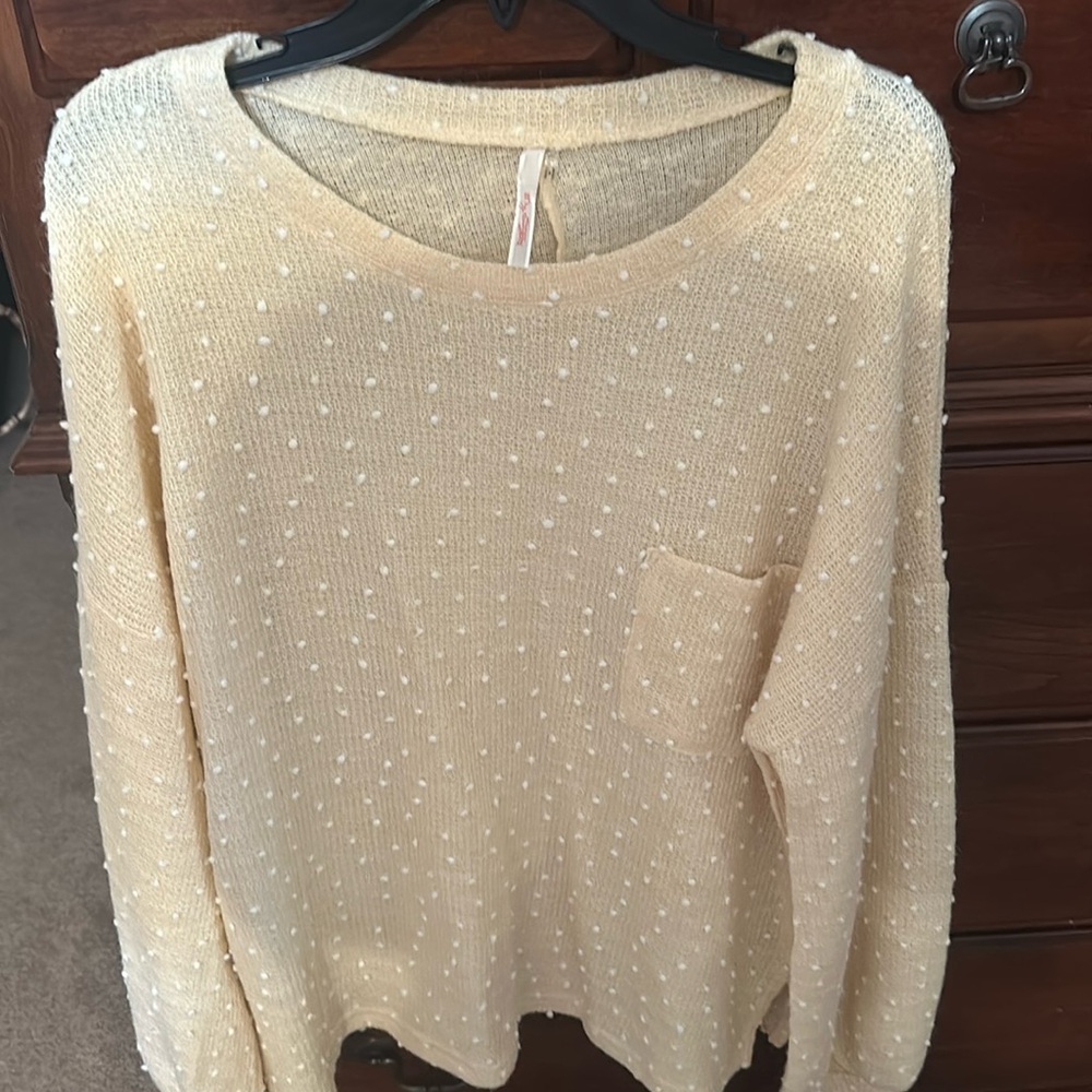 Yellow sweater with white pompoms